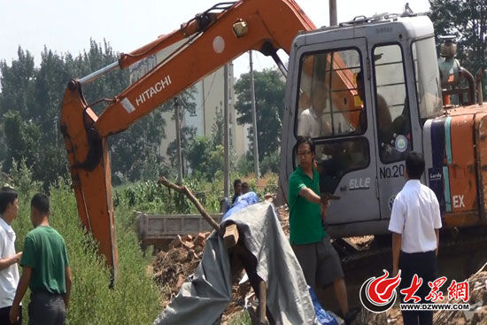 陳寶成手持自制刀斧守在挖掘機旁阻止便衣民警靠前。（視頻截圖）