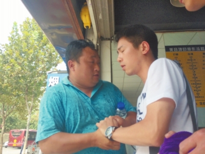 記者正查看照片，突遭藍(lán)衣男強(qiáng)搶手機(jī)。